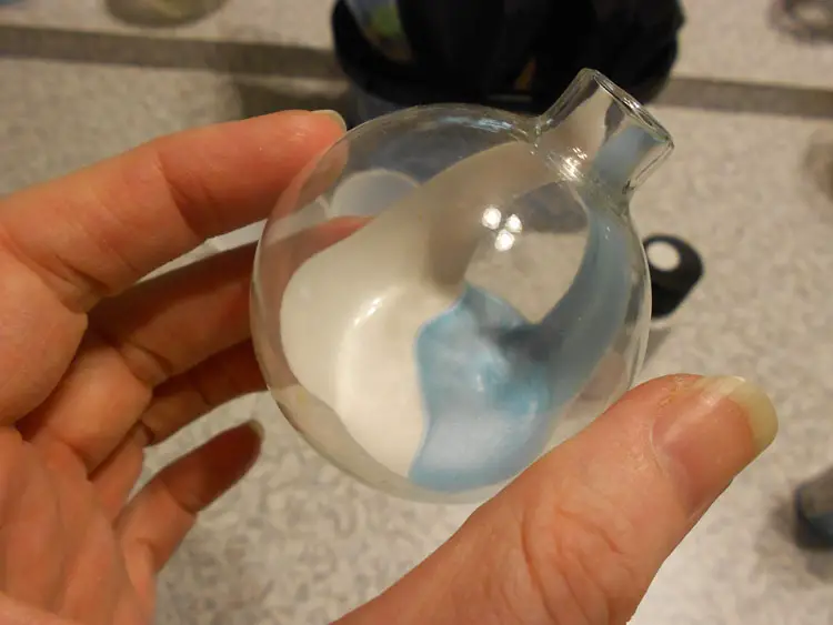clear glass ornament with paint dribbled inside
